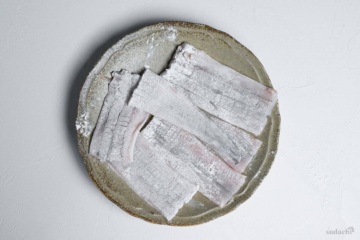 conger eel pieces coated in flour on a round brown plate