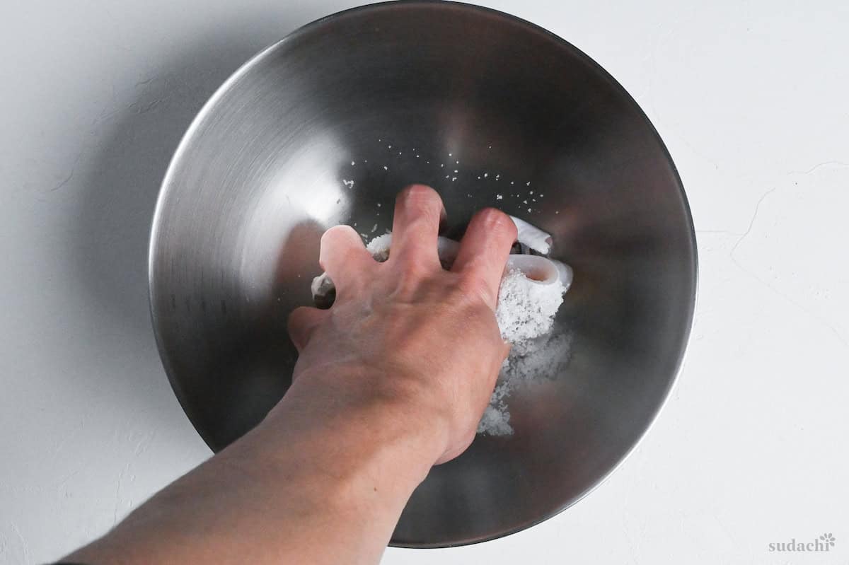 rubbing conger eel with salt in a mixing bowl