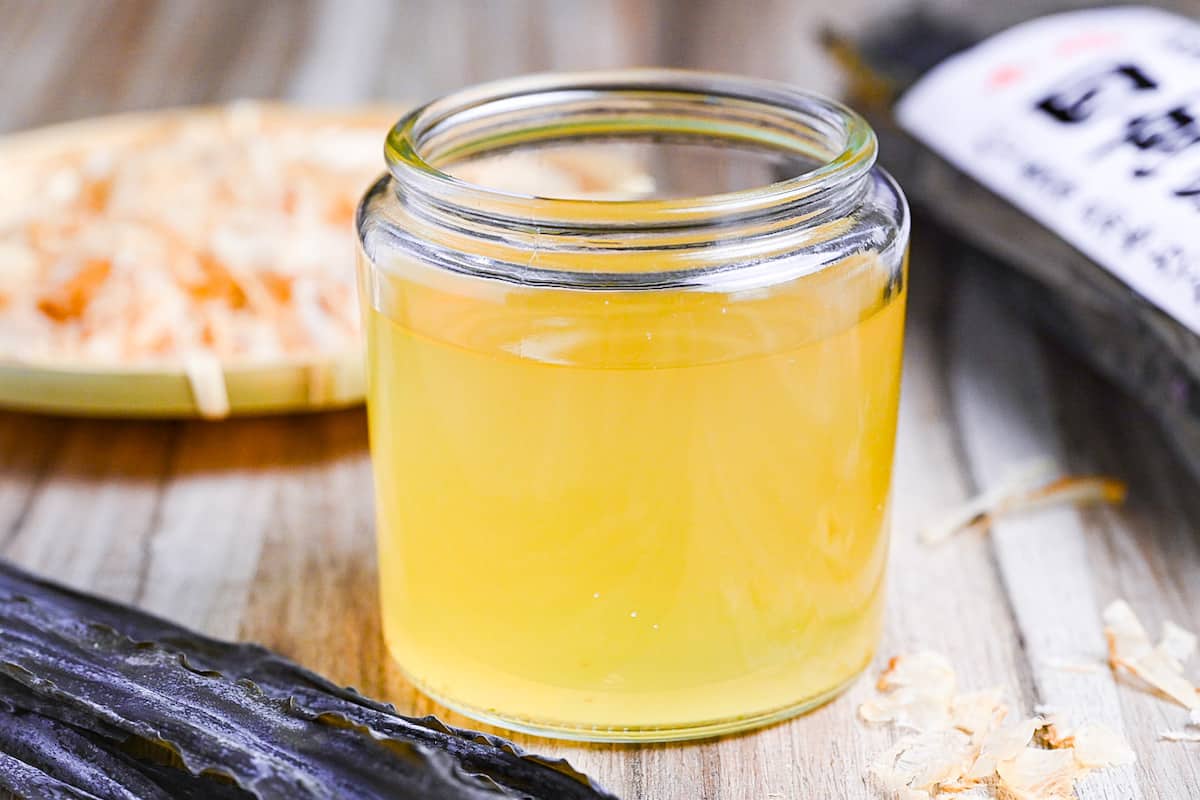 awase dashi in a jar with kombu in the foreground and katsuobushi in the background