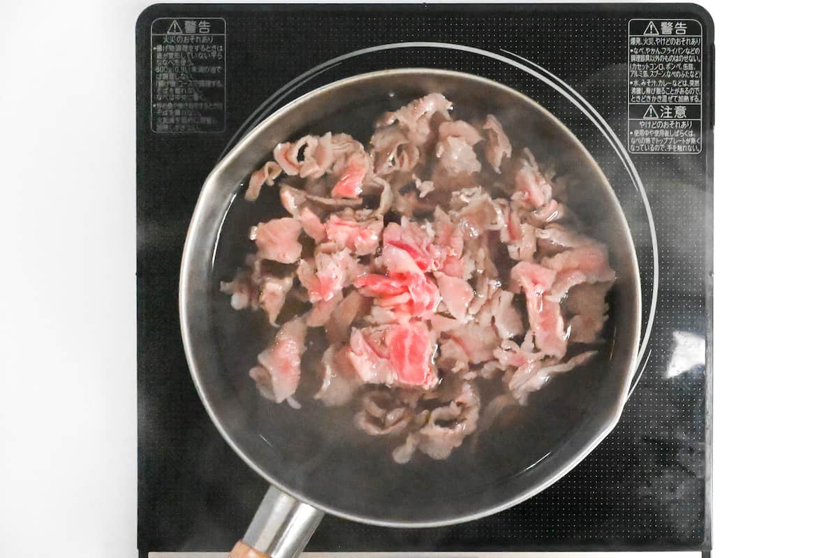 blanching thinly sliced wagyu beef in hot water