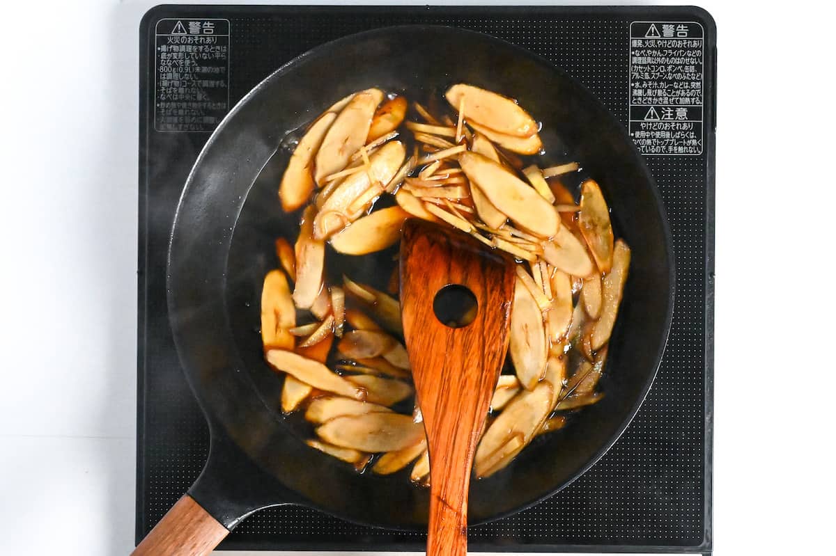 simmering burdock root in condiments and seasonings to make beef shigureni