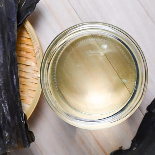 kombu dashi in a glass jar surrounded by kombu