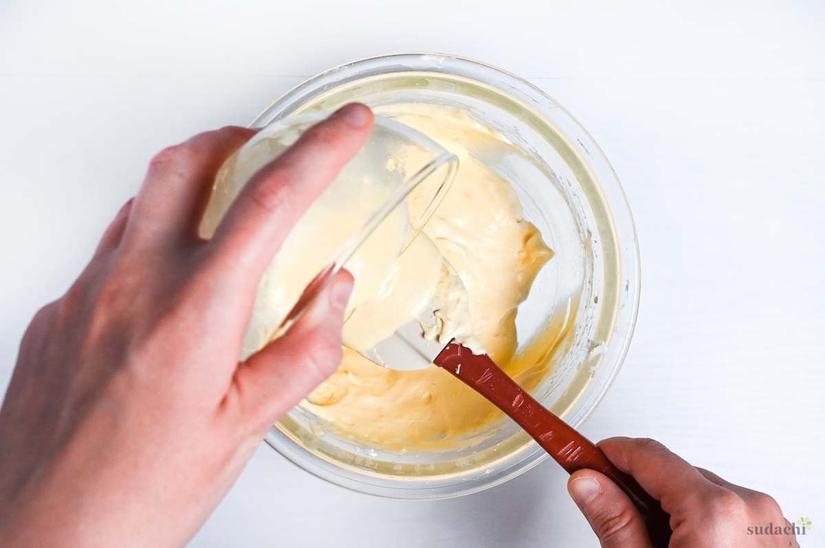 pouring oil, milk and batter into the rest of the batter