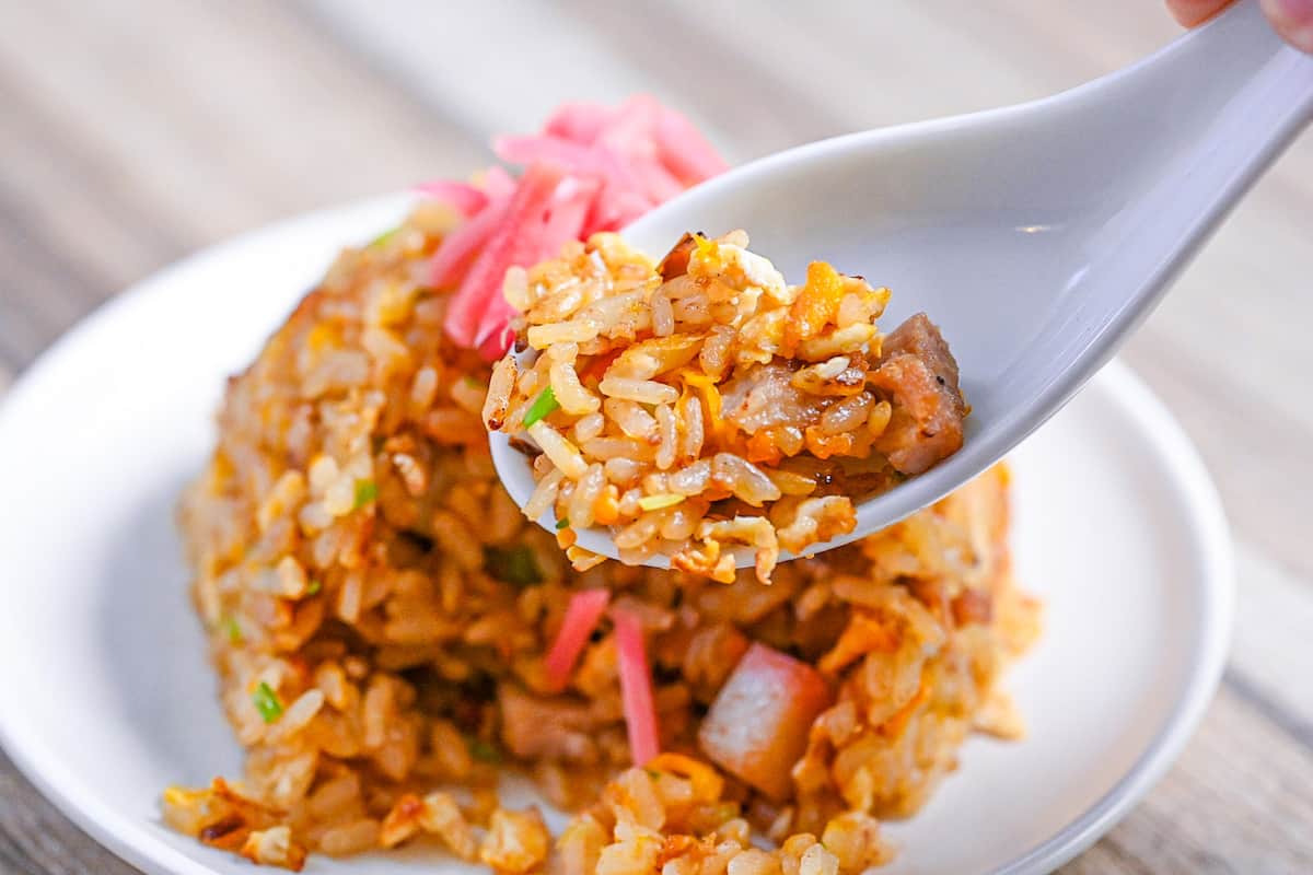 Japanese chahan (fried rice) on a white ceramic spoon