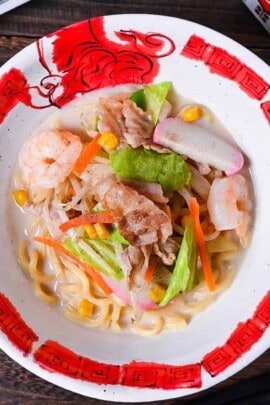 Ringer Hut Style Nagasaki Champon served in a white and red ramen bowl made with pork, shrimps and vegetables in a rich milky broth