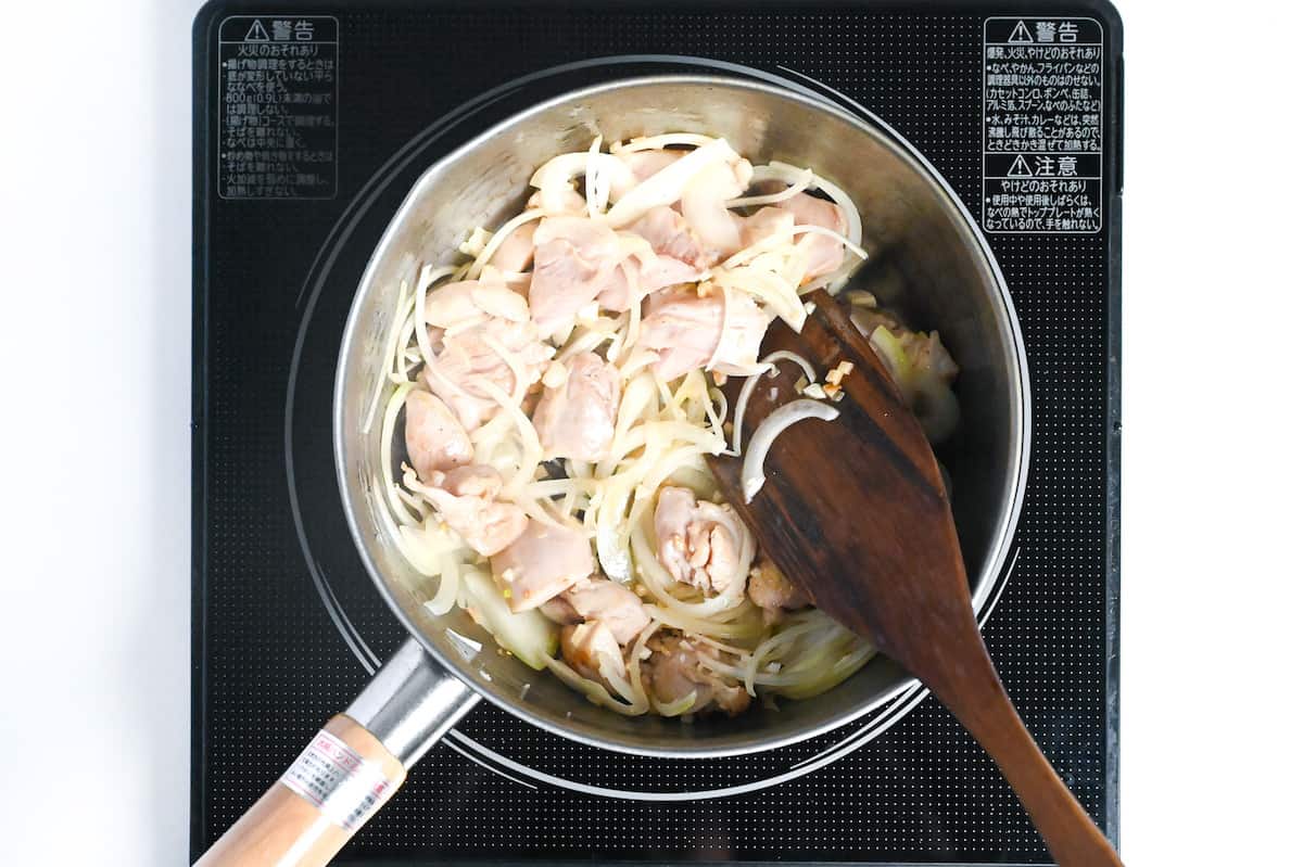 chicken, onion and aromatics in a pan