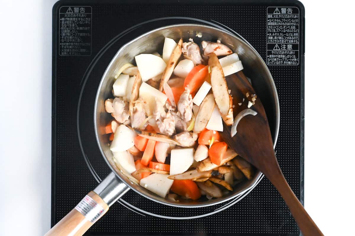 root vegetables added to pot with chicken, onion and aromatics