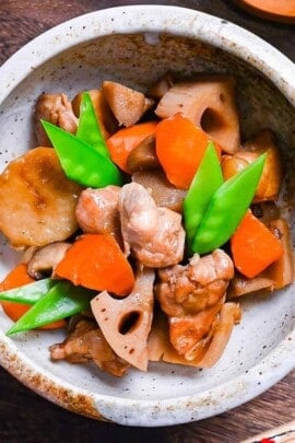 Chikuzenni (Japanese simmered chicken and vegetables) served in a mottled beige bowl