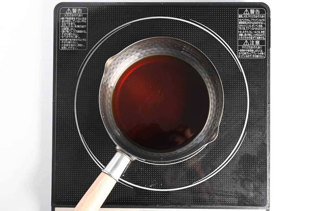 Boiling udon sauce in a small saucepan