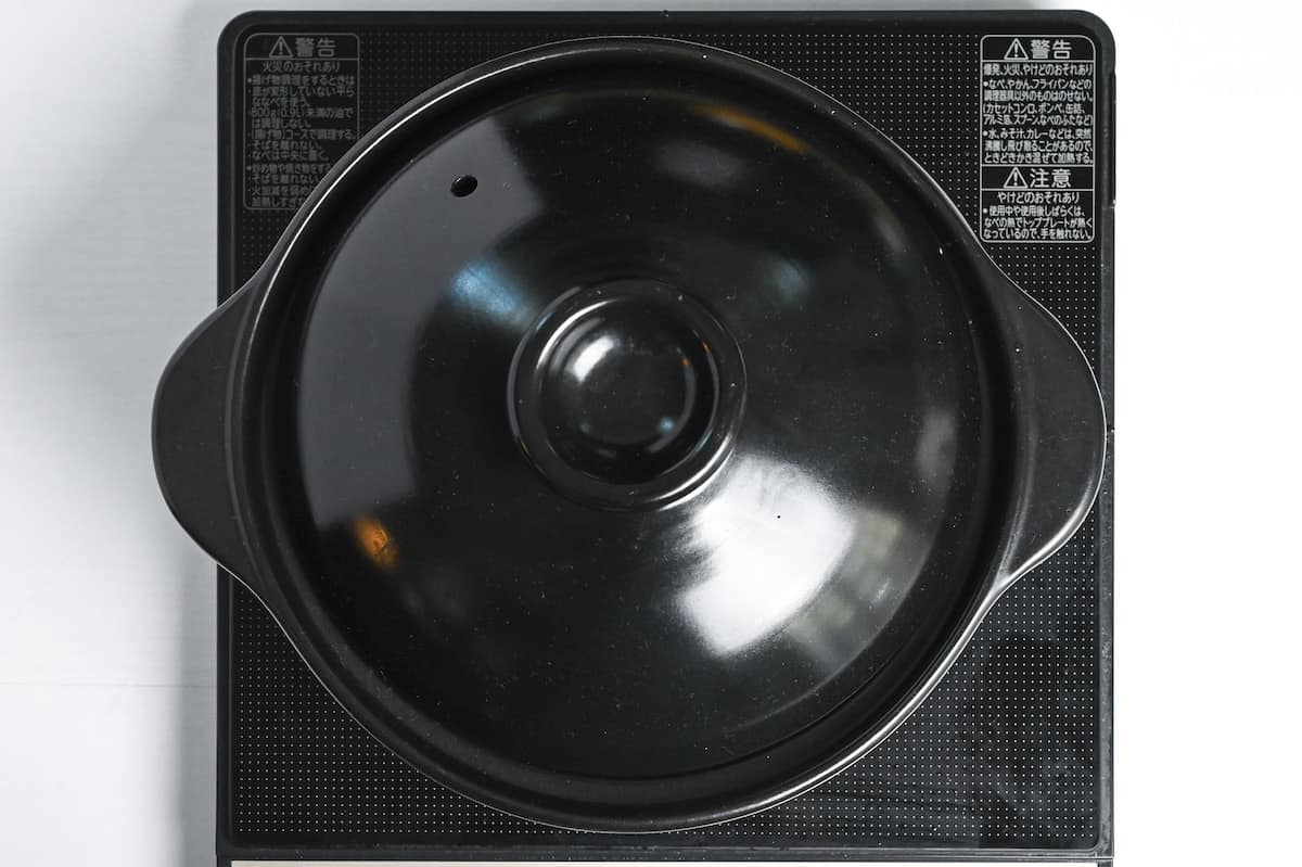 pot of rice with lid on stove