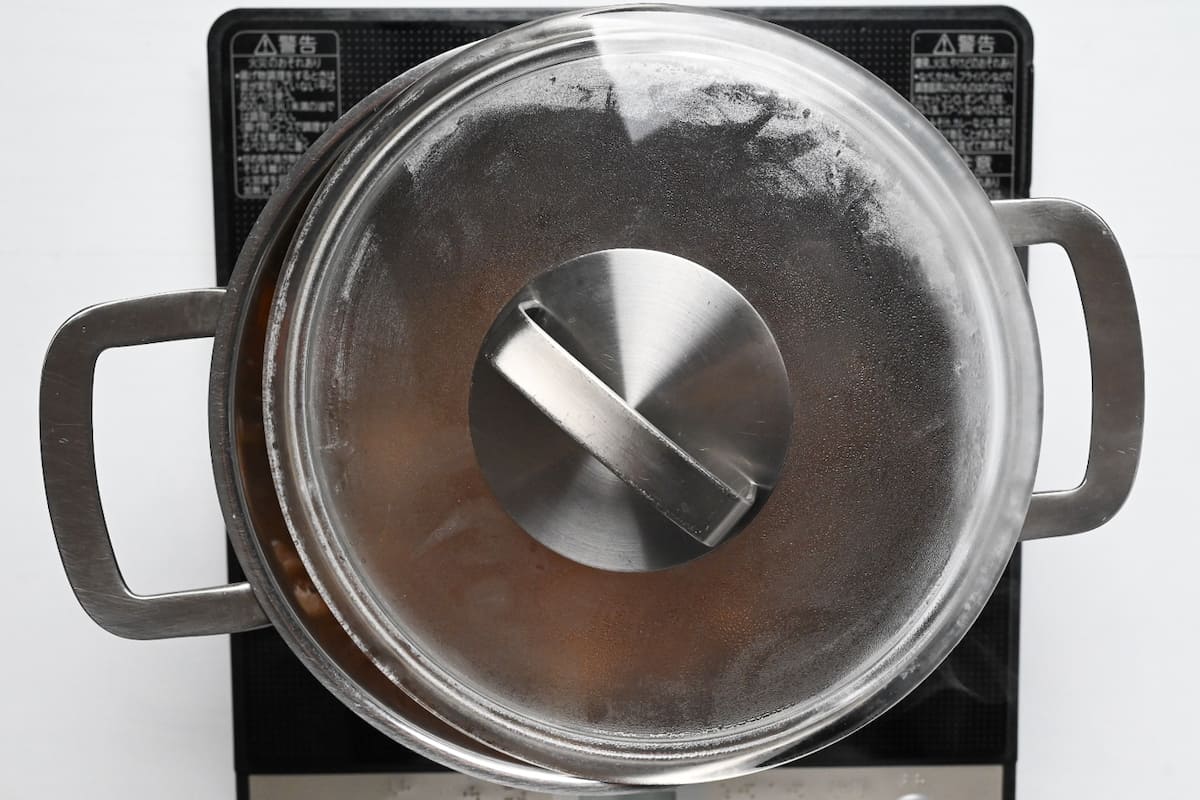 A lid placed ajar on a pot of Japanese curry