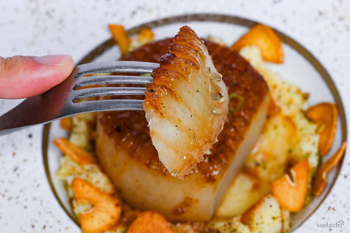 Close up of piece of daikon steak on a fork