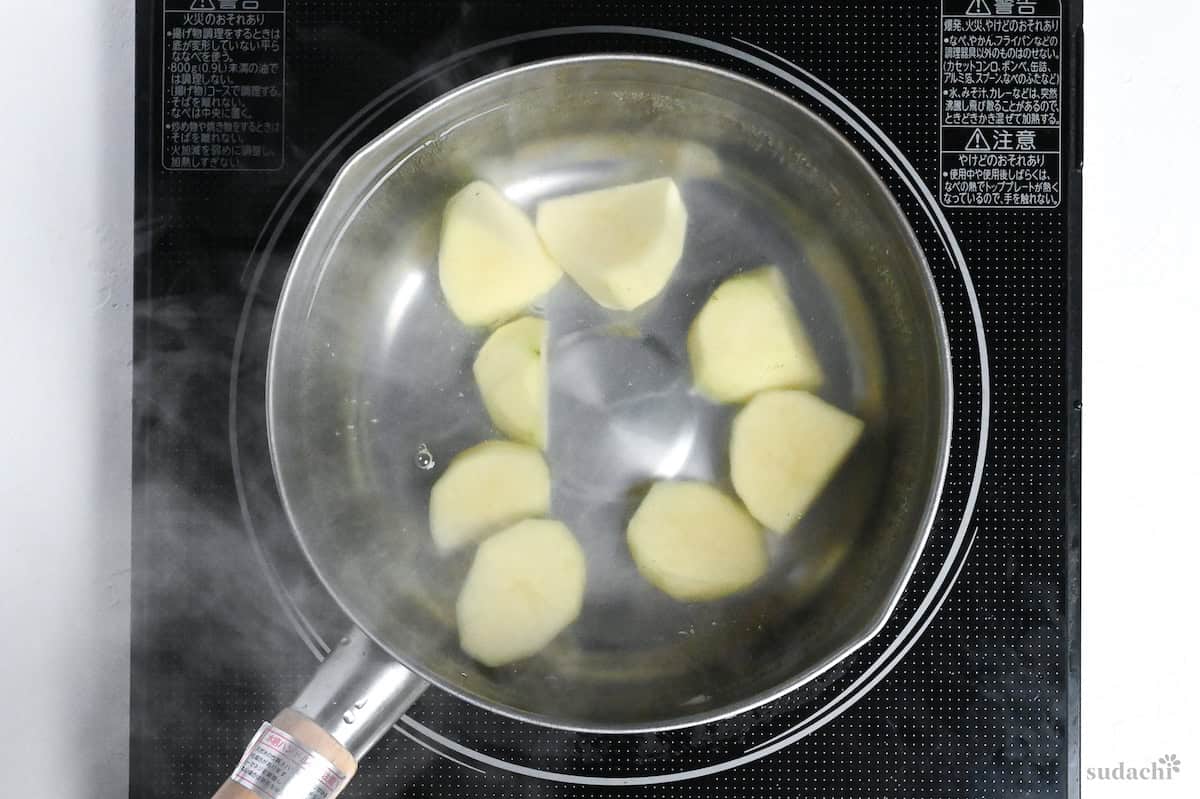 boiling potatoes in a pot of water on the stove