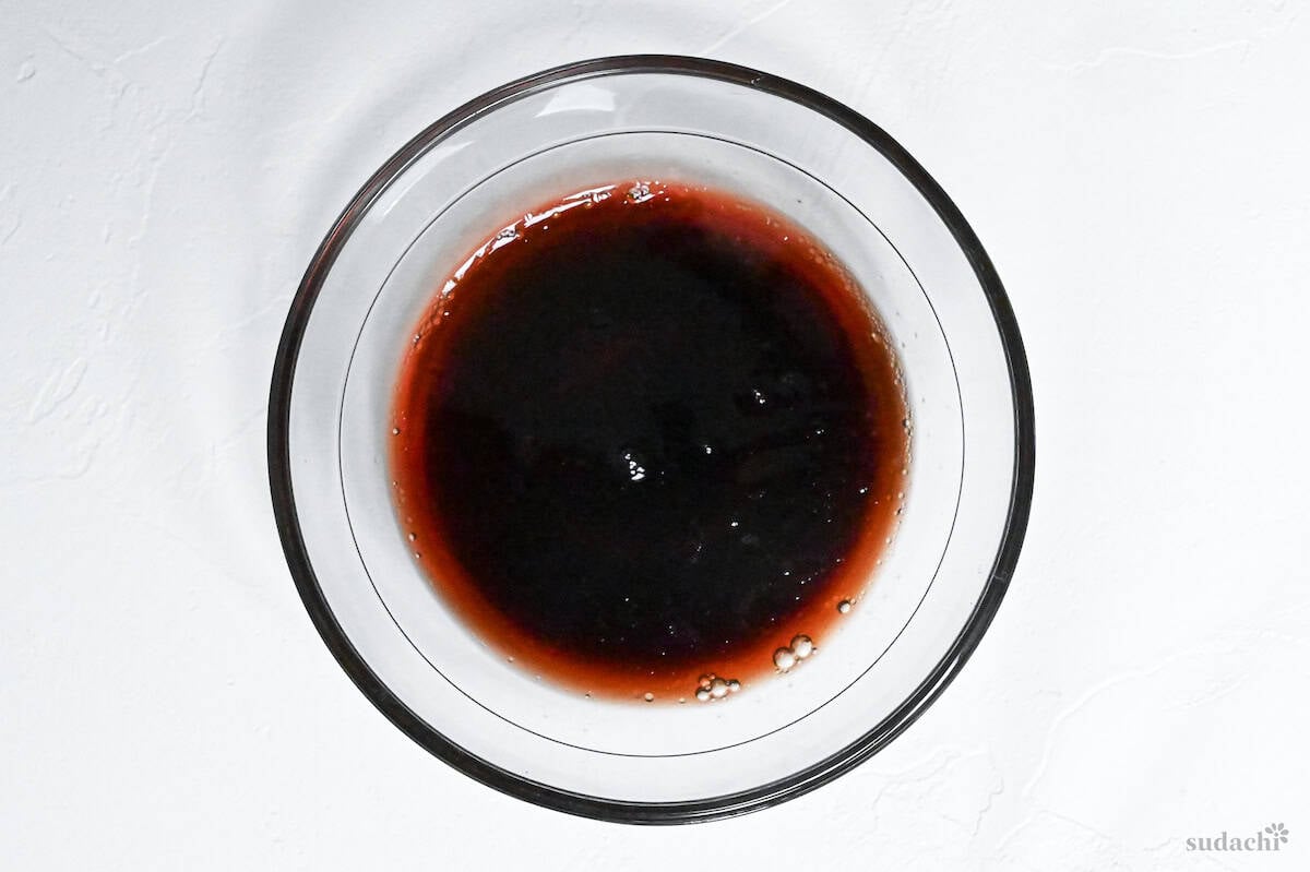 sauce for daikon steak mixed in a small glass bowl on a white background
