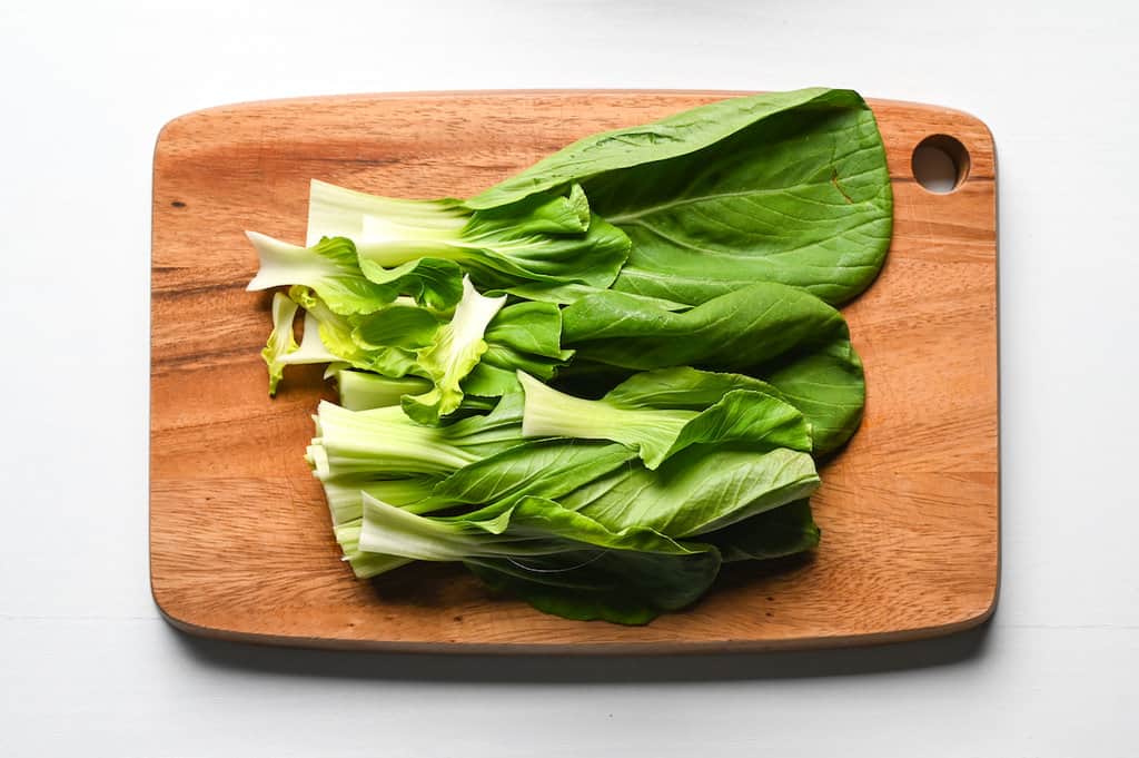 pak choi on wooden chopping board
