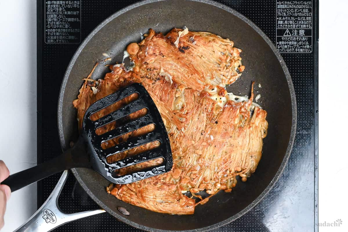 crispy enoki mushrooms flipped to reveal golden top, cheese melting underneath