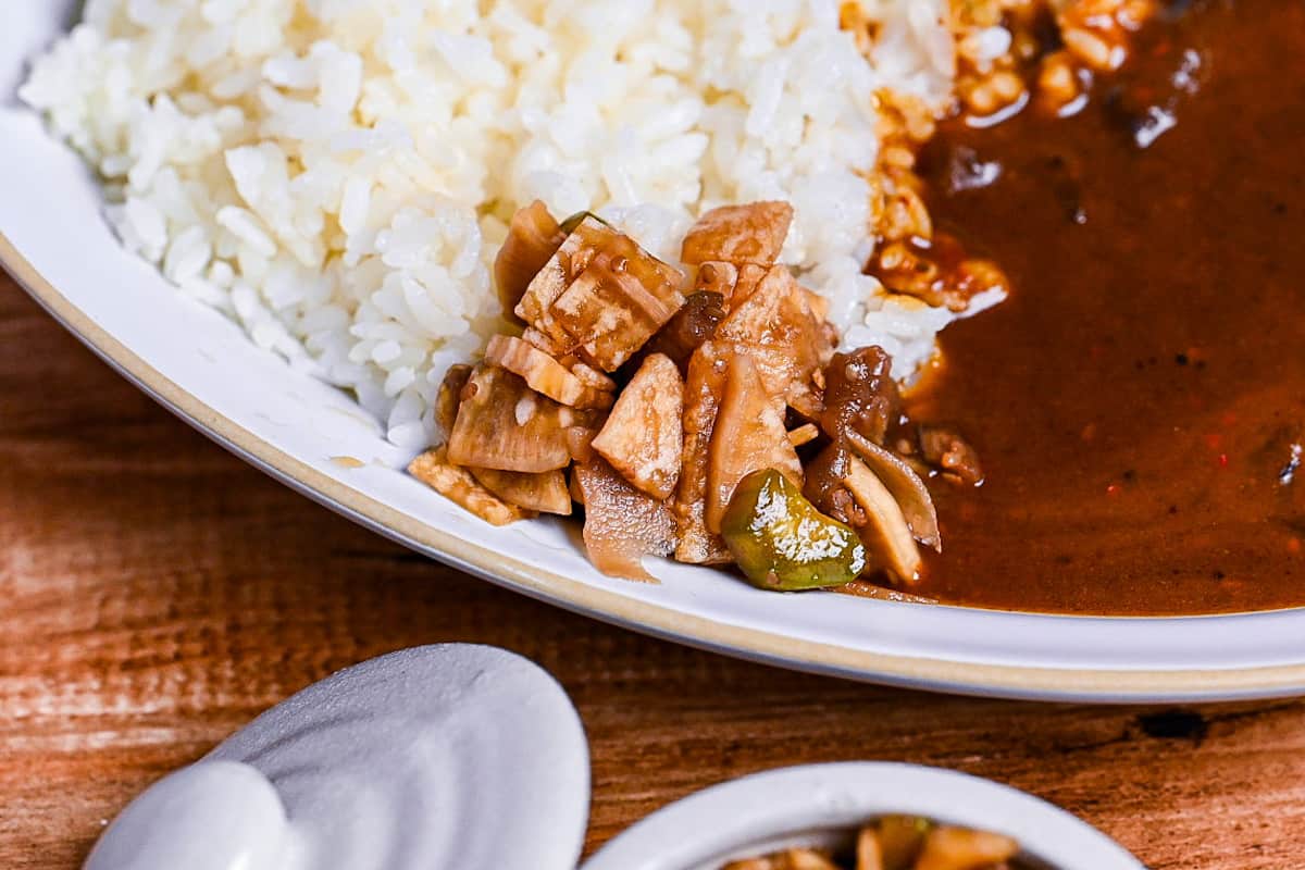 a close up of fukujinzuke pickles served with Japanese curry rice