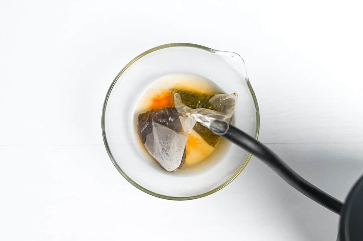 Pouring hot water over hojicha tea bags