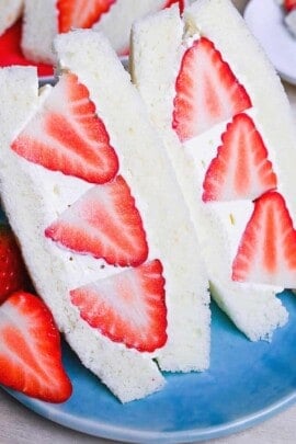 Japanese ichigo sando (strawberry sandwich) cut into triangles on a blue plate