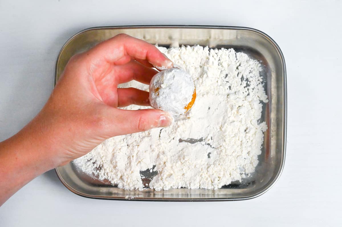 coating kabocha korokke with flour