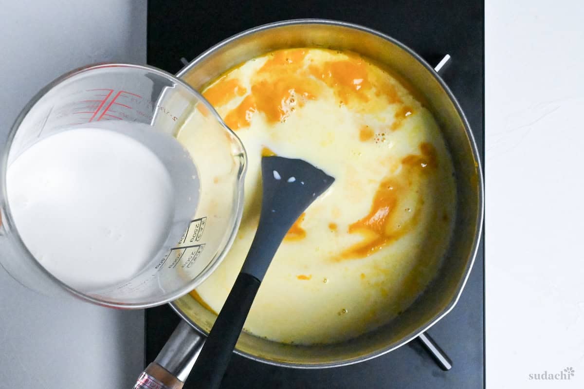 adding milk and cream to kabocha soup