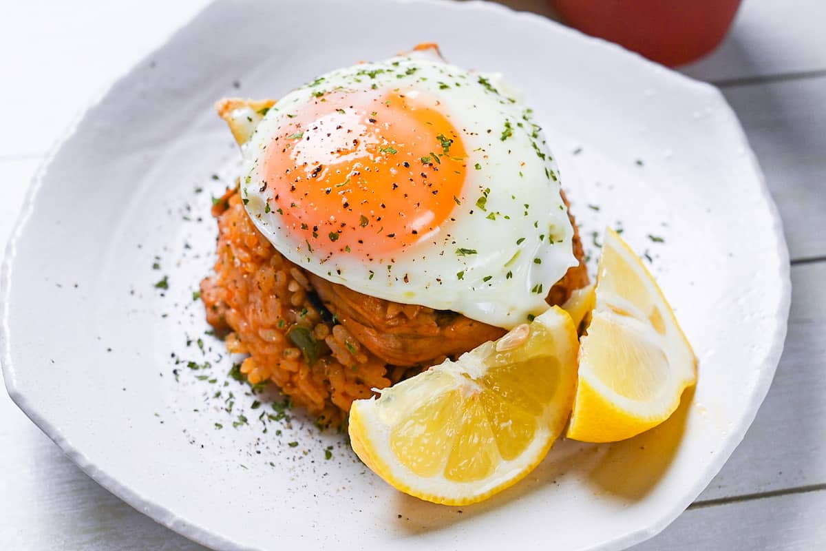Japanese ketchup rice (chicken rice) topped with egg and served with lemon wedges