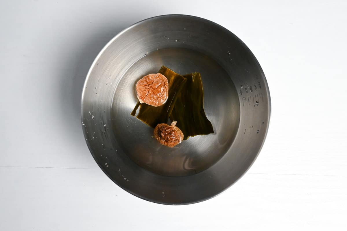 Kombu and shiitake dashi in a bowl with water
