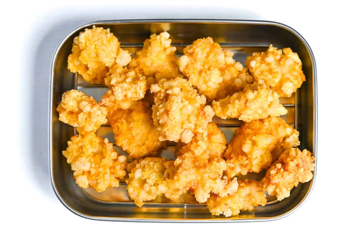 lemon chicken karaage on a wire rack after first fry