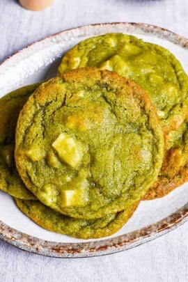 matcha green tea and white chocolate cookies on a white plate with a brown rim