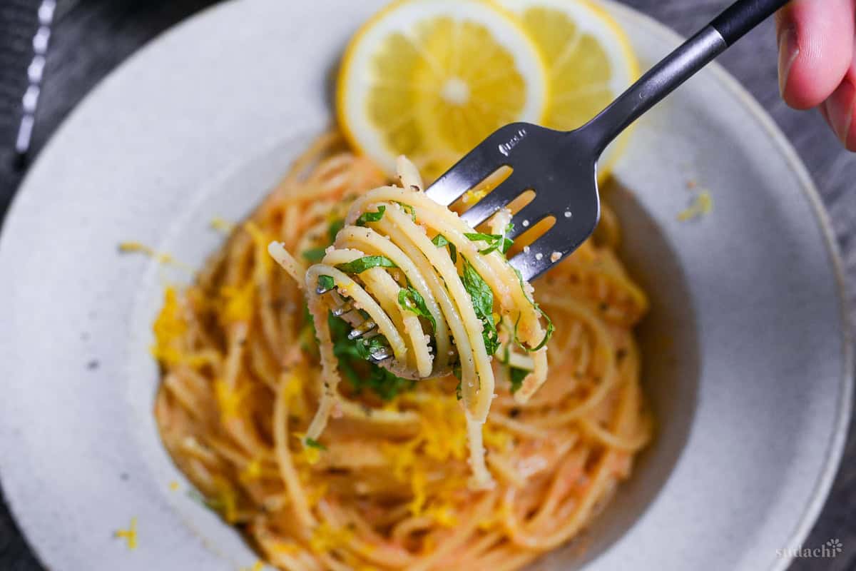 close up of mentaiko pasta twirled around a fork