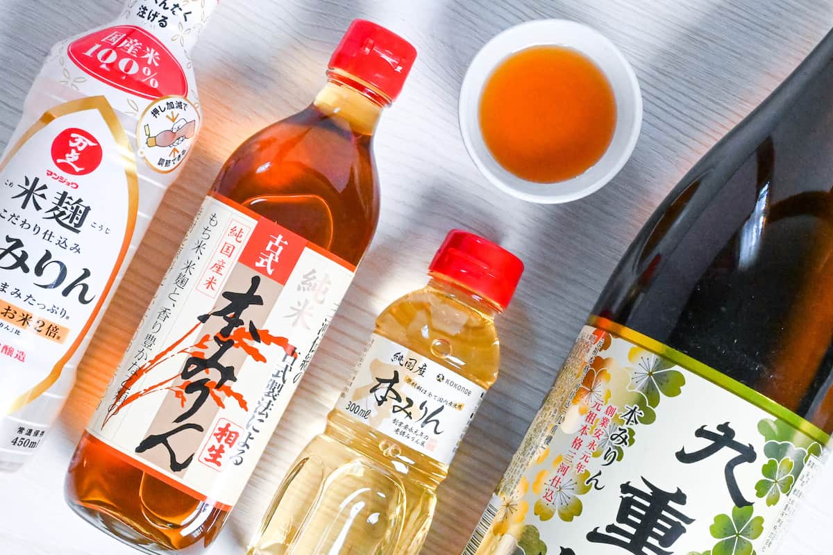 Bottles of Japanese hon mirin (Sweet rice wine seasoning) with some poured in a small white bowl