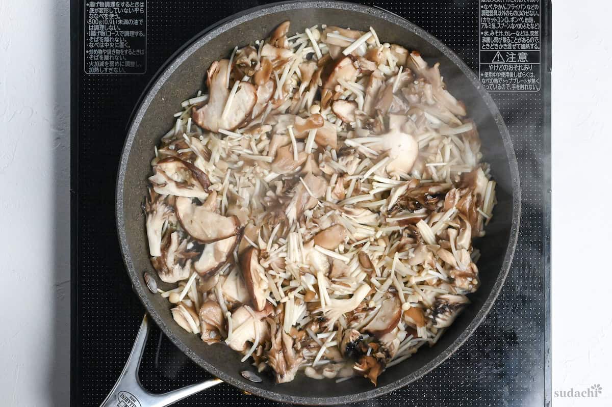 Japanese mushrooms frying in a pan on the stove top
