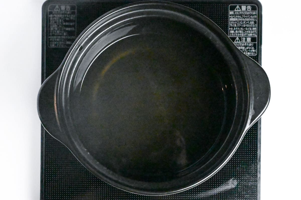 dashi in a black hot pot on the stove