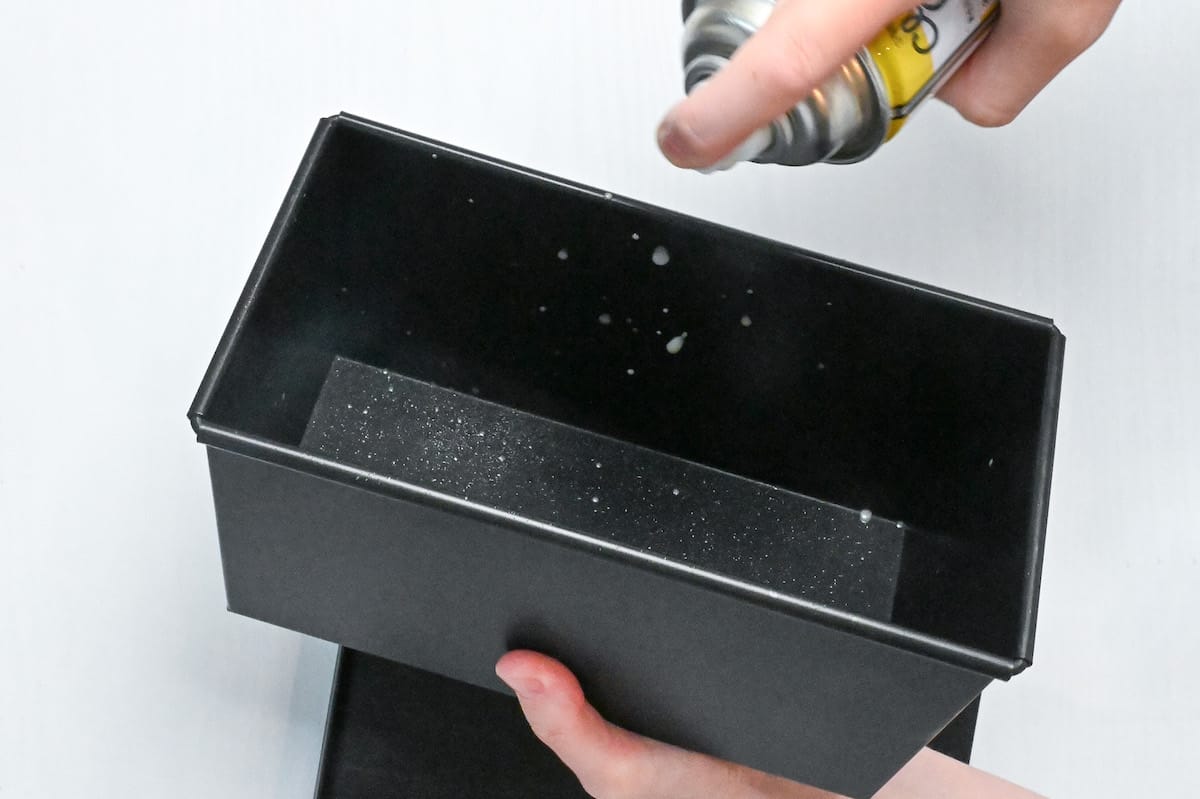 spraying loaf pan with spray release