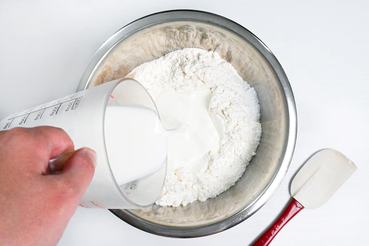 pouring liquid into dry ingredients to make nama shokupan