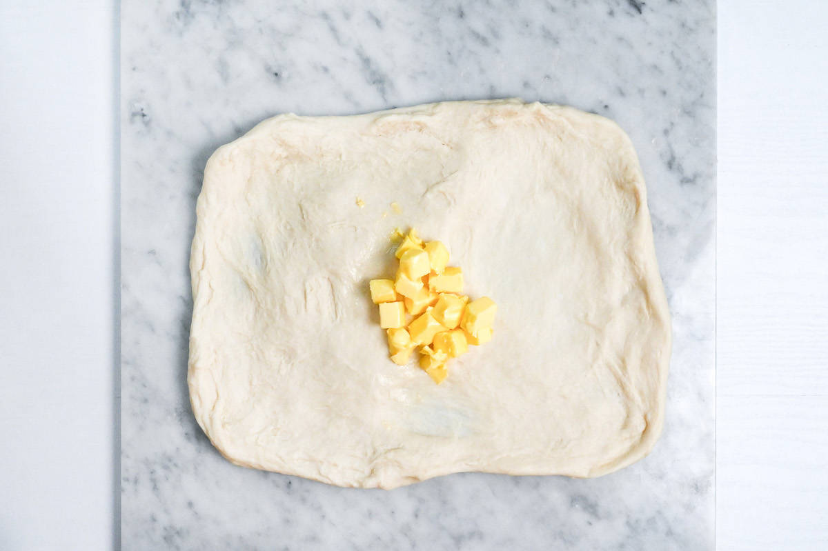 nama shokupan dough stretched with cubed butter in the center