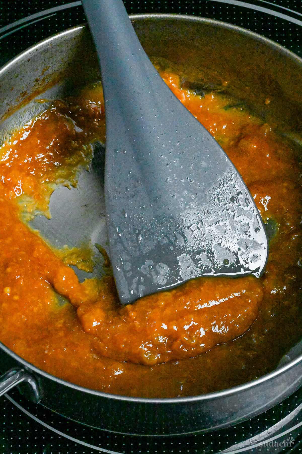 Miso glaze for nasu dengaku reducing in a saucepan on the stove