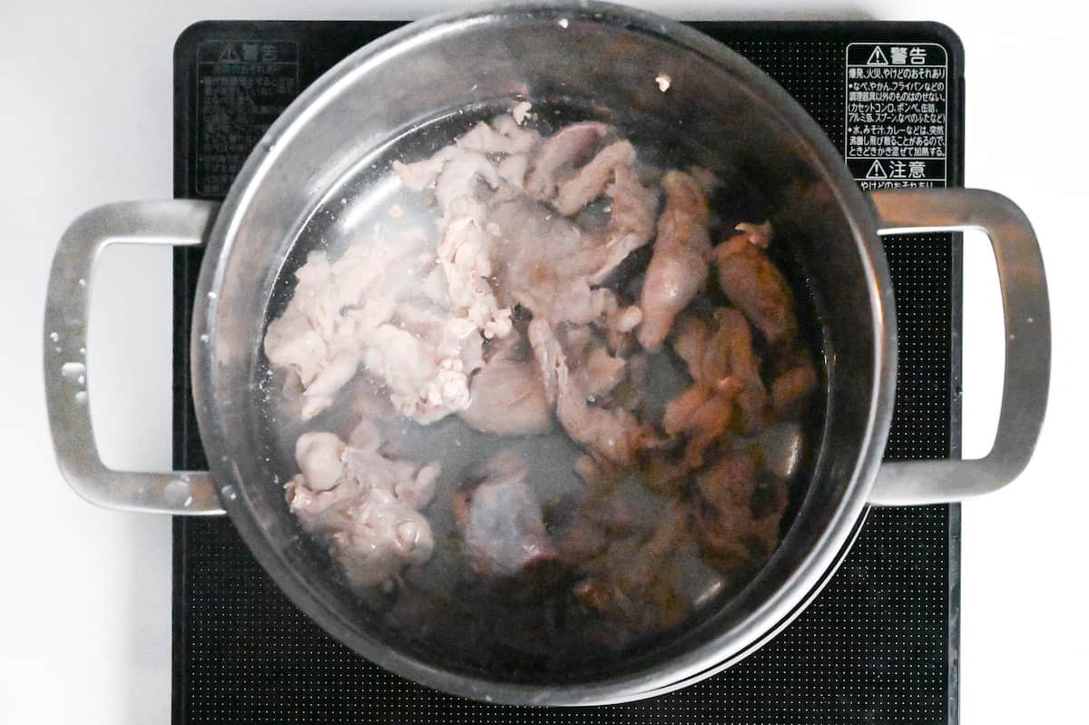 beef sinew in a pot of water on the stove