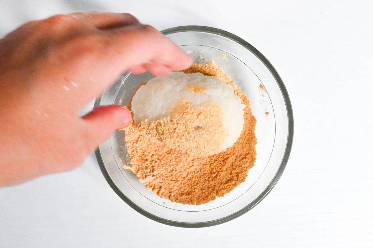 rolling ohagi in kinako (roasted soy bean powder)