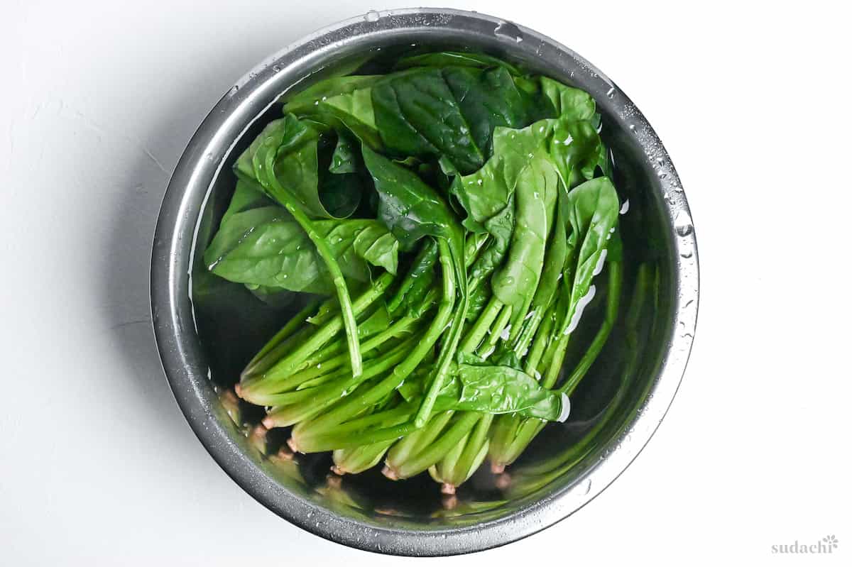 washed spinach in a bowl of water