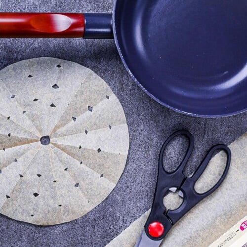 A variety of Japanese drop lids (otoshibuta) on a gray background