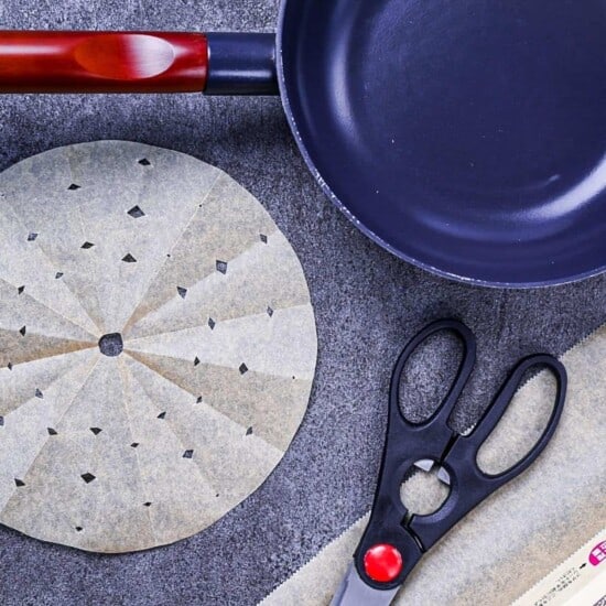 A variety of Japanese drop lids (otoshibuta) on a gray background