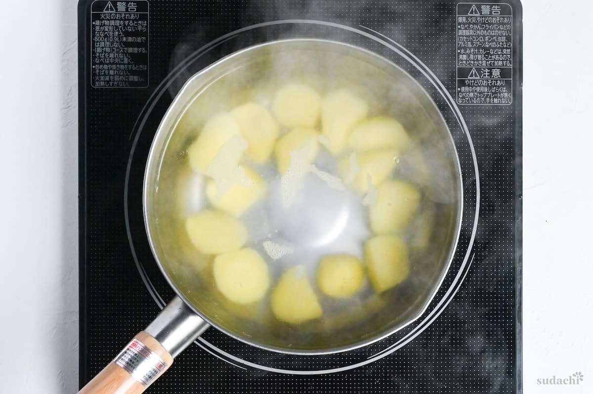 starchy potatoes in a pot of hot water on the stove top