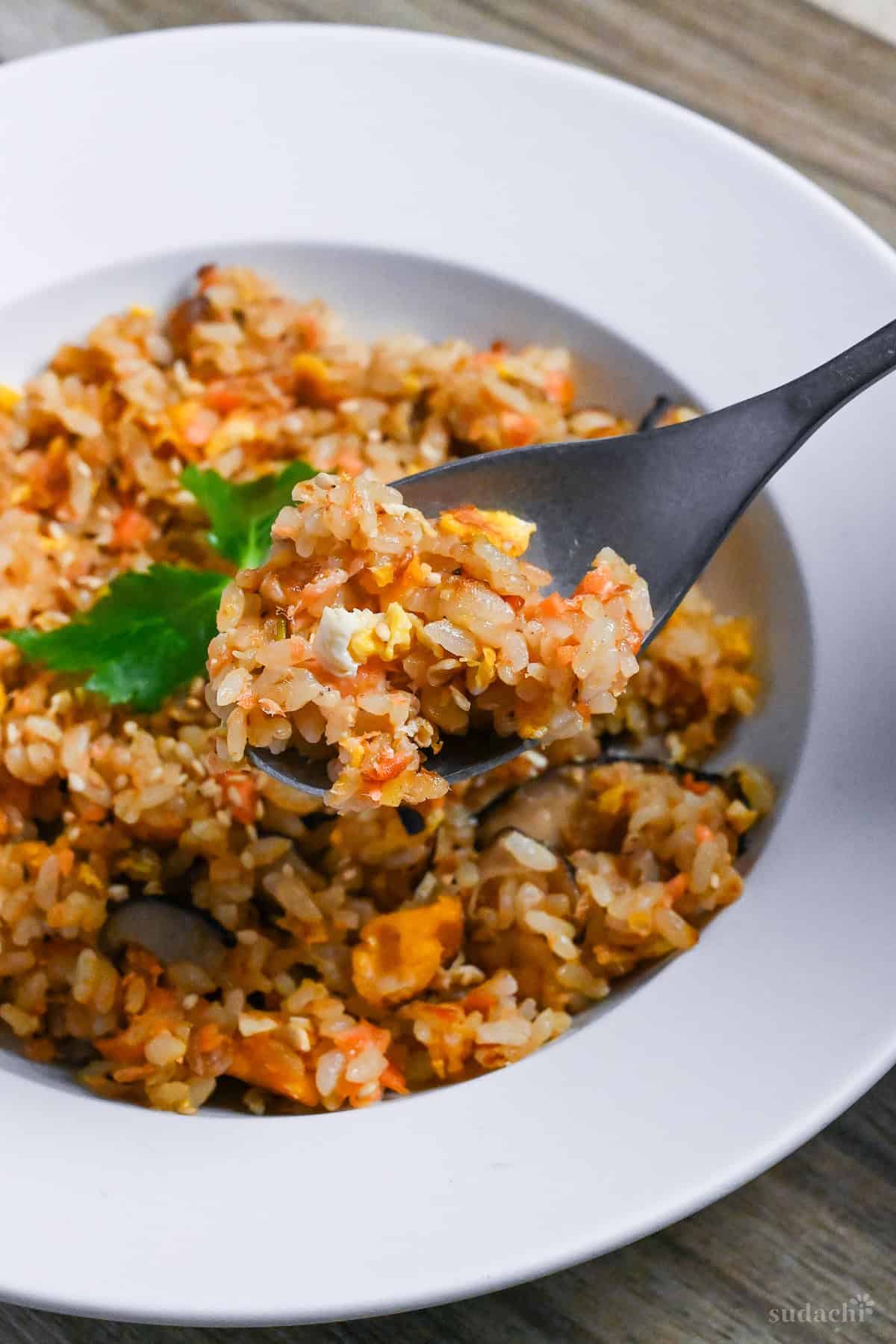 Salmon fried rice on a silver spoon