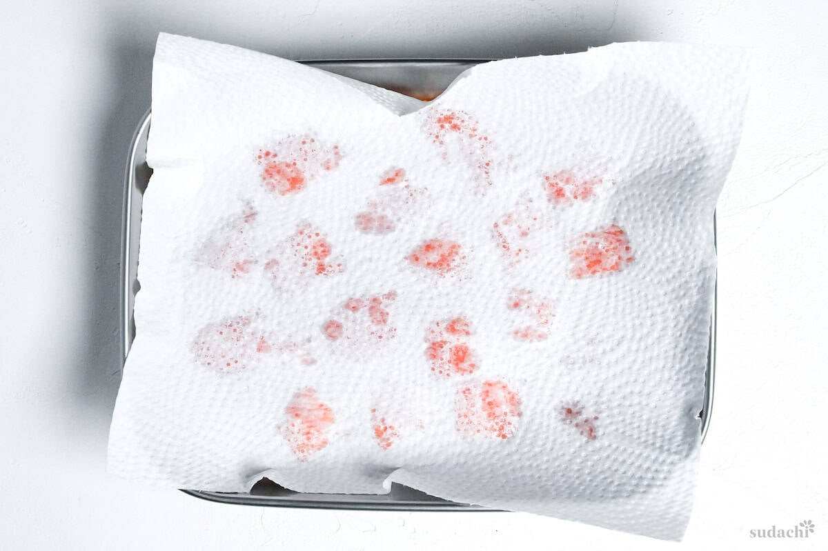 drying salted salmon pieces with kitchen paper