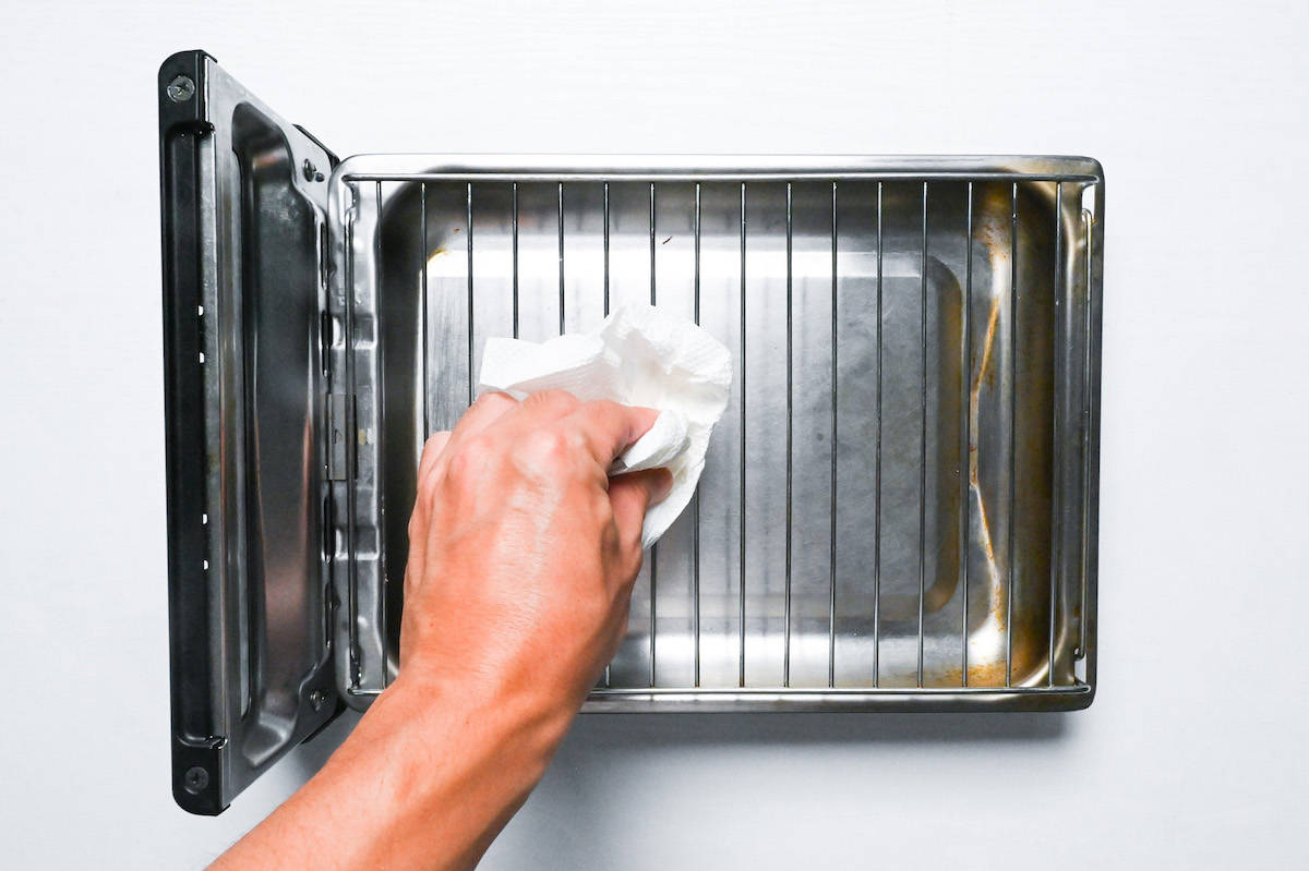 wiping oil on fish grill