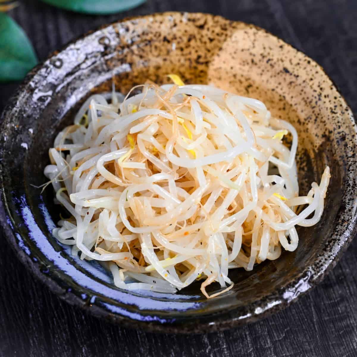 Seasoned Bean Sprouts for ramen in a black and beige Japanese-style bowl