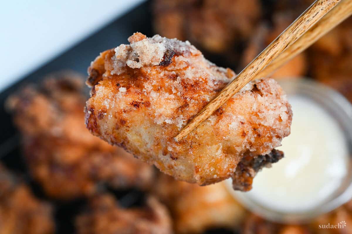 close up of completed shio koji karaage held up with chopsticks