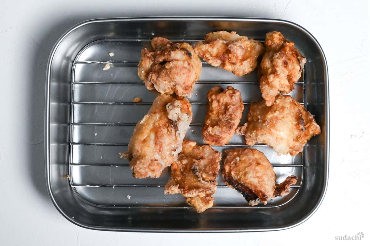 shio koji karaage on a wire rack after first fry