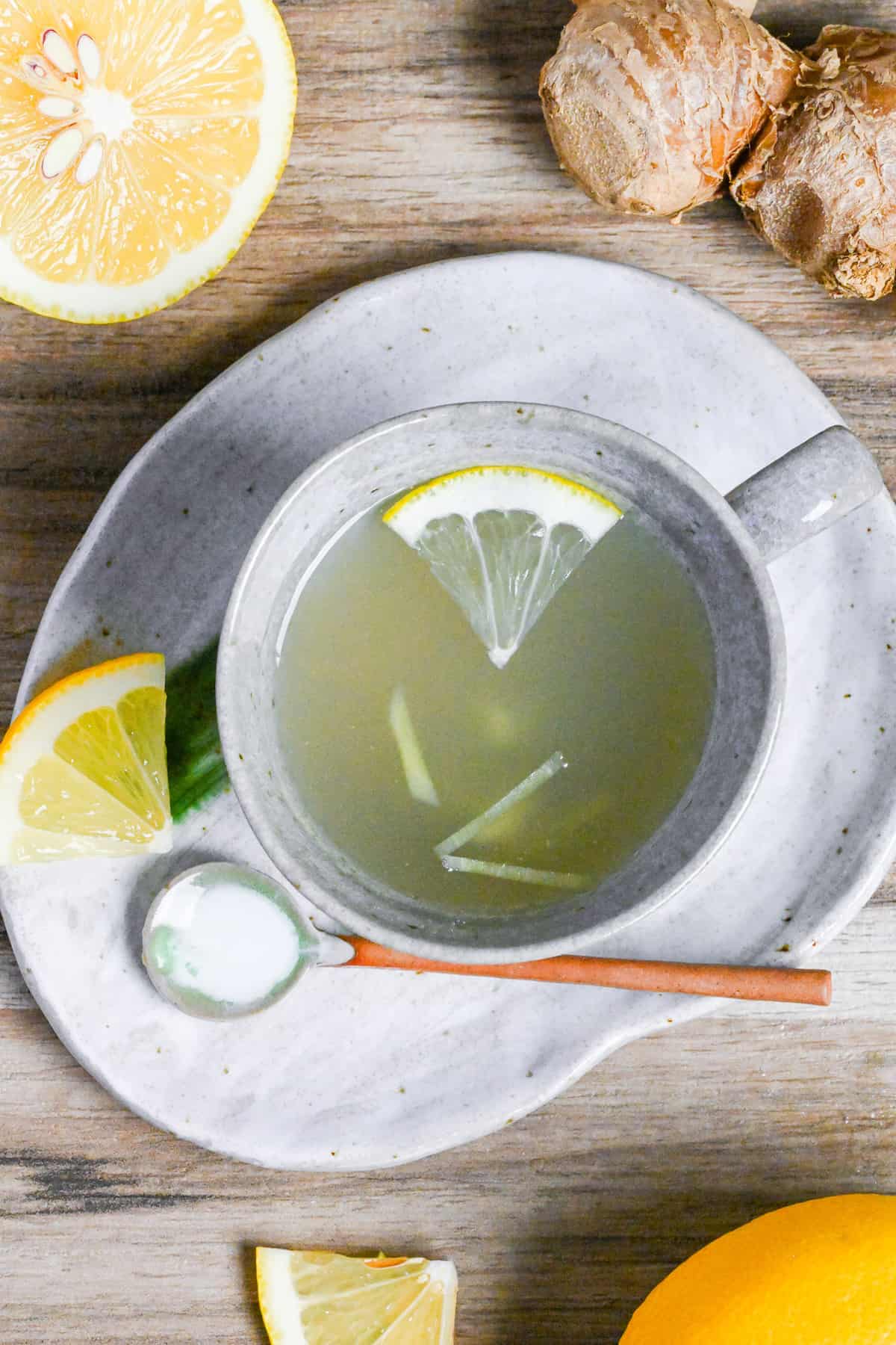 Japanese ginger tea (shogayu) in a gray cup with lemon and ginger pieces